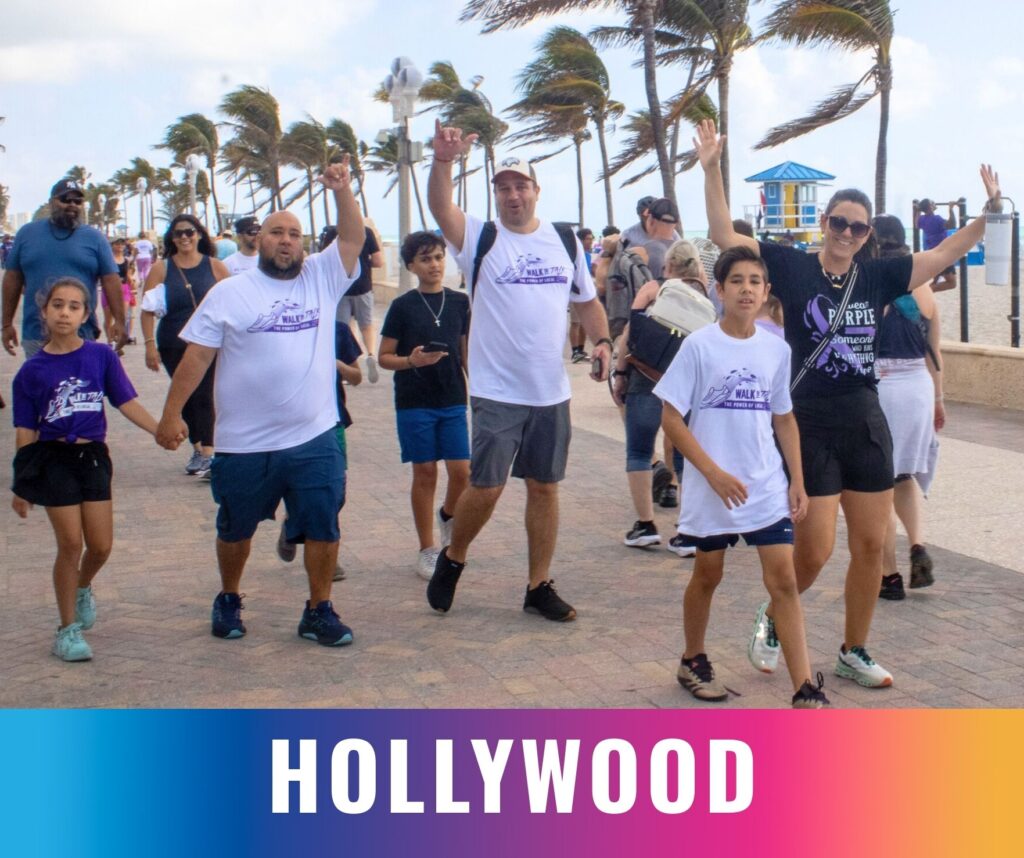 Families and participants walk together along the beachfront at the Walk the Talk epilepsy awareness event in Hollywood, Florida.
