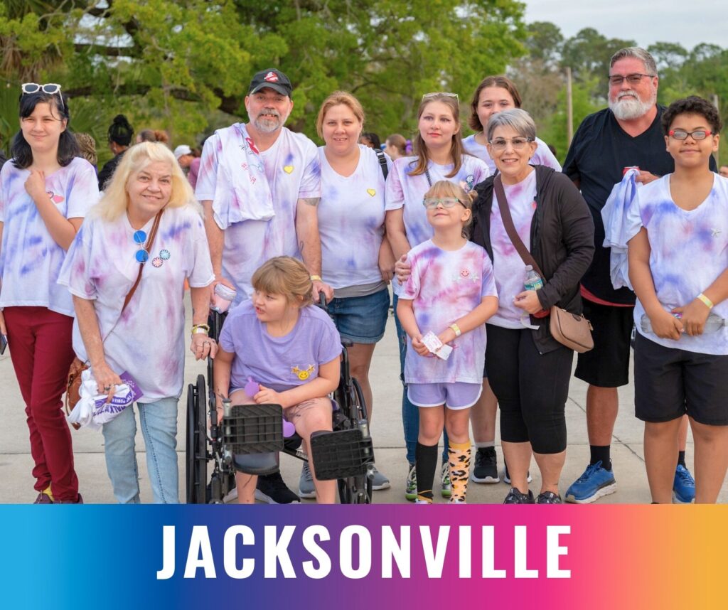 Families and participants stand together and smile at the Walk the Talk epilepsy awareness event in Jacksonville.
